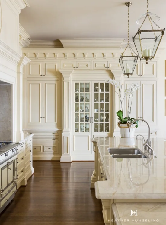 This wide display unit, featuring beveled glass cabinet doors, is designed to look like a piece of furniture tucked into the surrounding cabinetry.