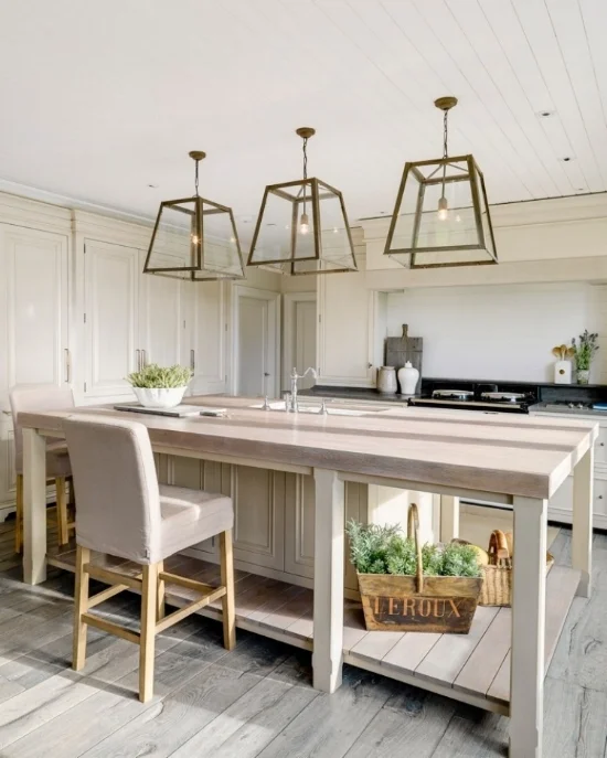 Cream kitchen cabinets work nicely with the aesthetic of this kitchen and pair well with the bleached oak island countertop. Designed by Andrew Ryan Design.