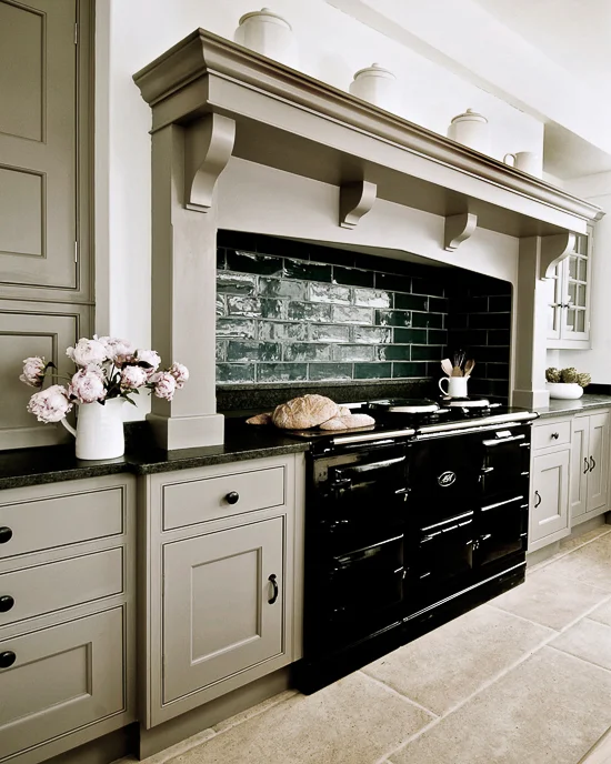 While cream colored AGA cookers were popular in the past, black ones seem to dominate the market now. English kitchen by Thomas Ford & Sons.