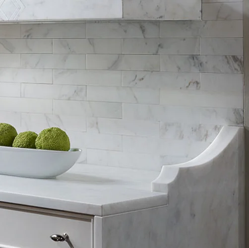 Marble brackets have been combined with the effect of a waterfall countertop in this kitchen. See the rest of my 9 Kitchen Marble Ideas for using more of the marble that you love.