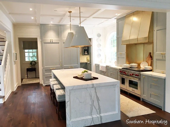 A marble waterfall island top gets a special paneled detail that visually softens it just a bit for this traditional kitchen. See more of my 9 Kitchen Marble Ideas…for When You Really Love Marble.