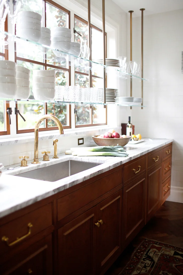 Shelving in front of windows is having a “moment” in kitchen design for 2019, such as in this beautiful kitchen by Katie Hackworth. Kitchen Trends 2019 . #kitchentrends, #luxurykitchens, #kitchendesignideas