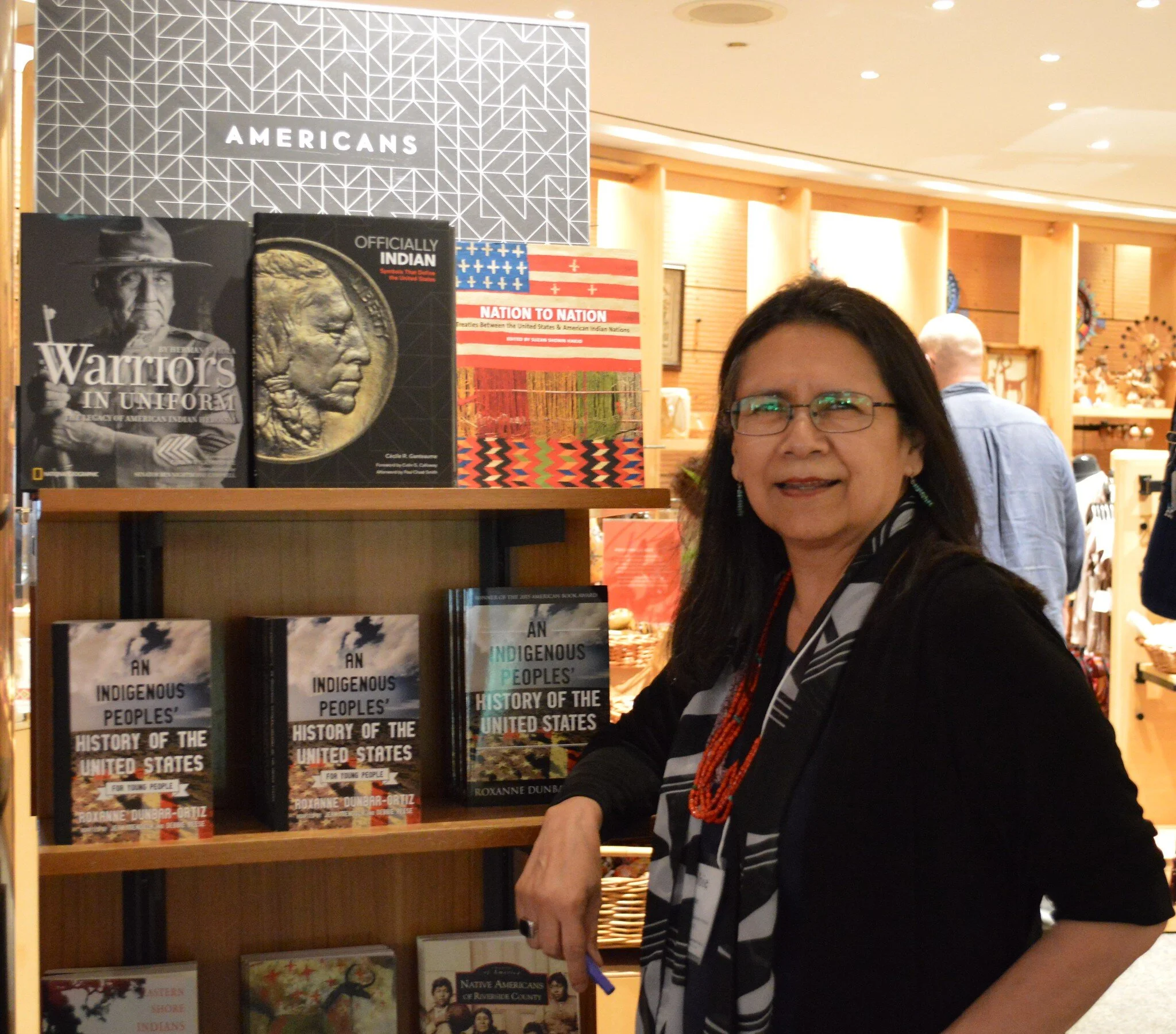 Debbie Reese preparing for book signing at the NMAI bookstore.