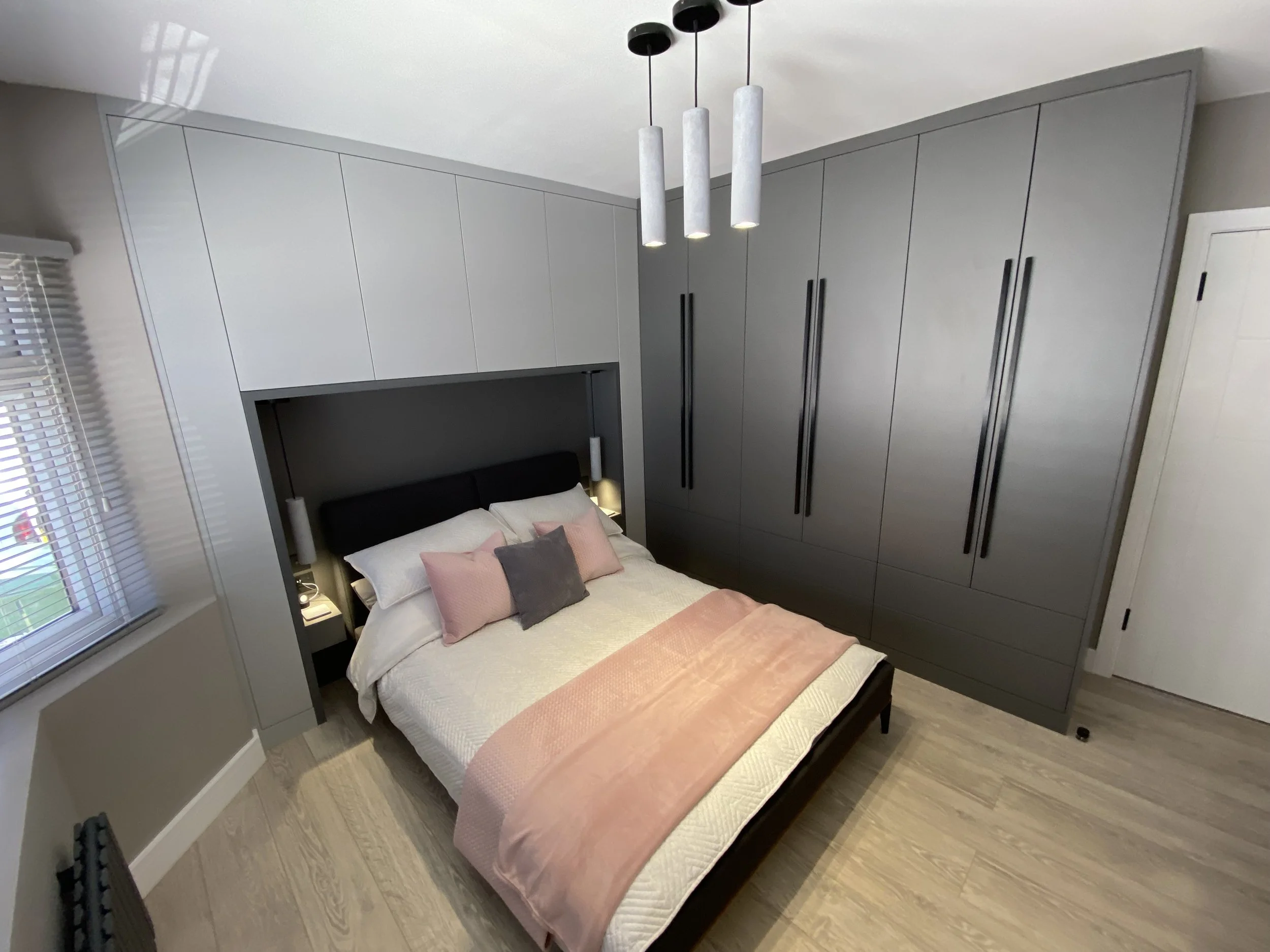 Bespoke fitted wardrobes in Shoreham-by-Sea with floor-to-ceiling grey cabinetry and integrated bedroom storage