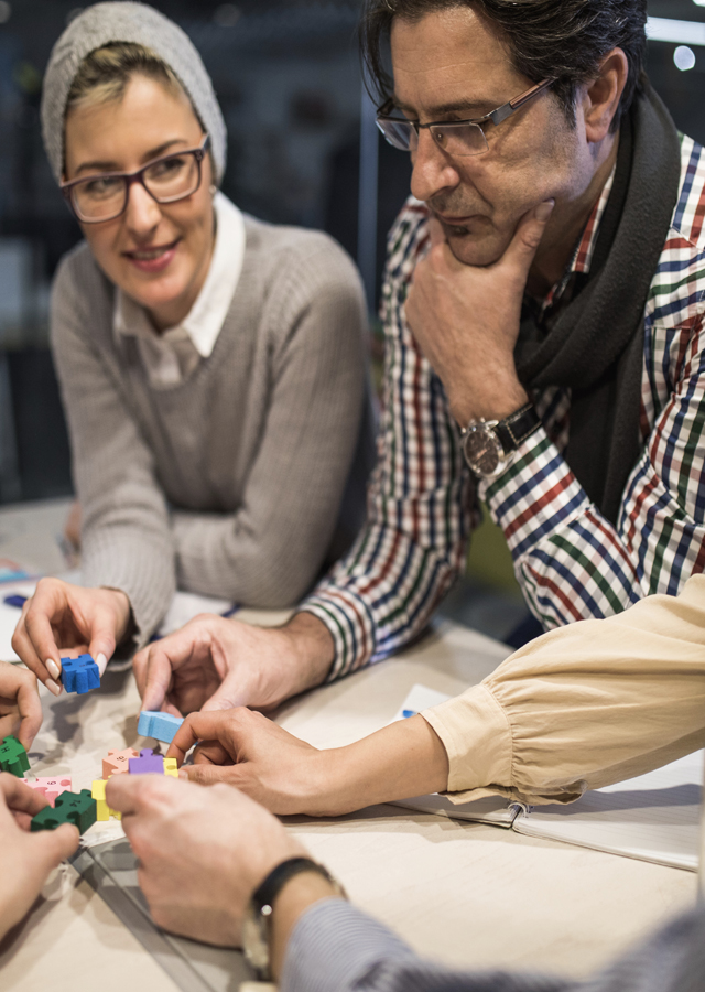 People solve complex puzzles as part of a team building competition