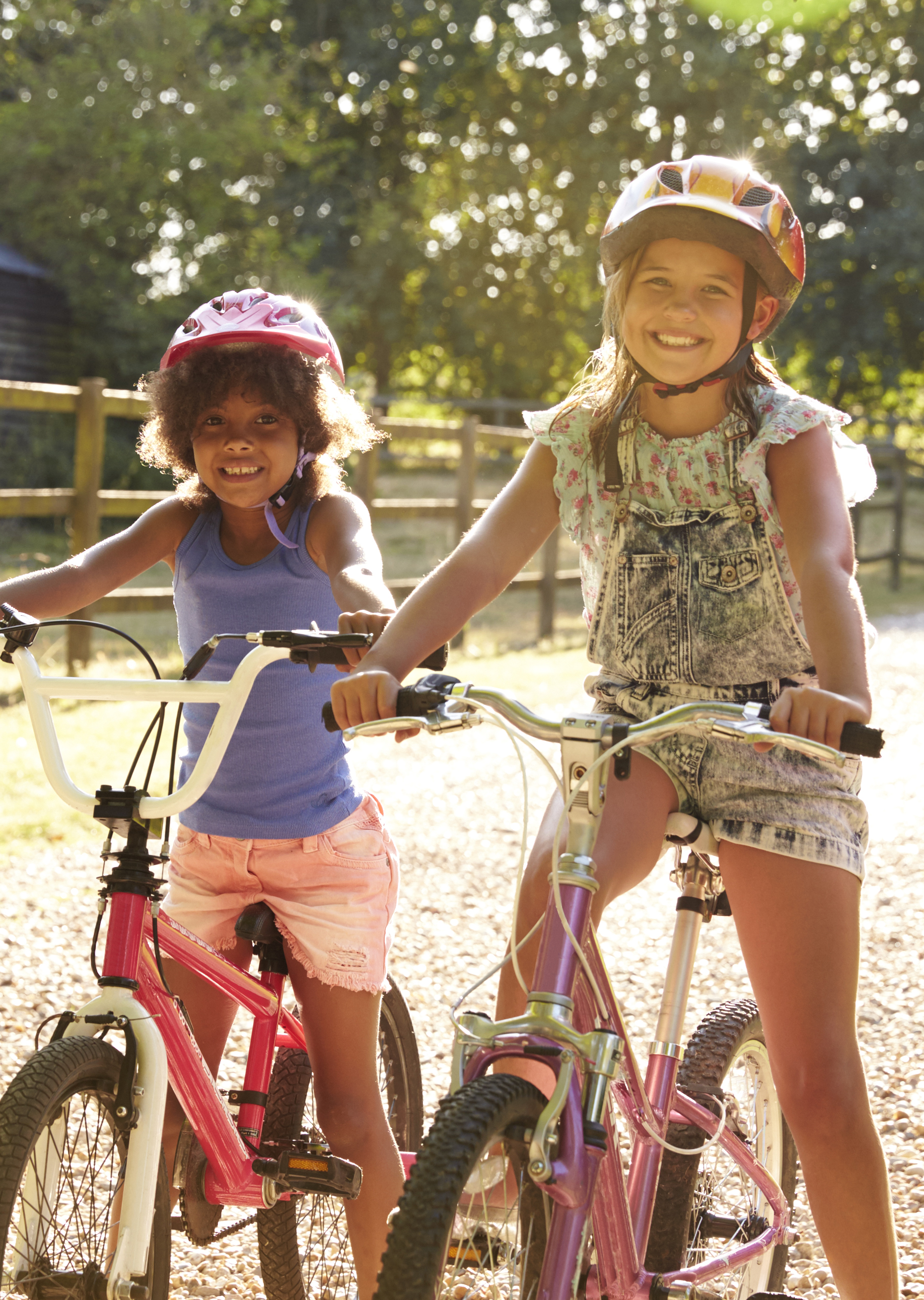 Two girls sitting on bicycles