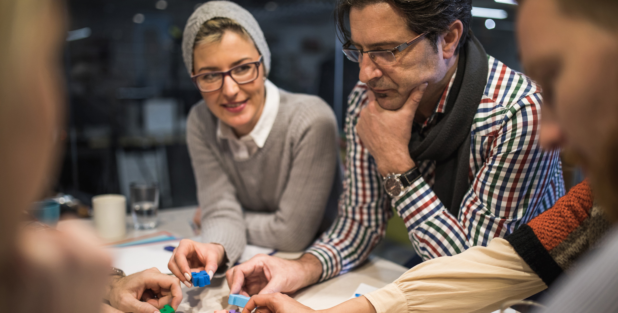 People solve complex puzzles as part of a team building competition