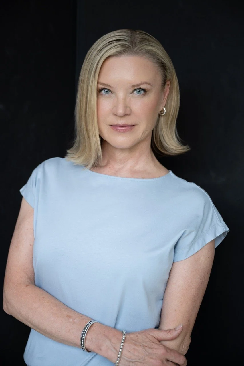 headshot woman standing blue shirt.jpeg