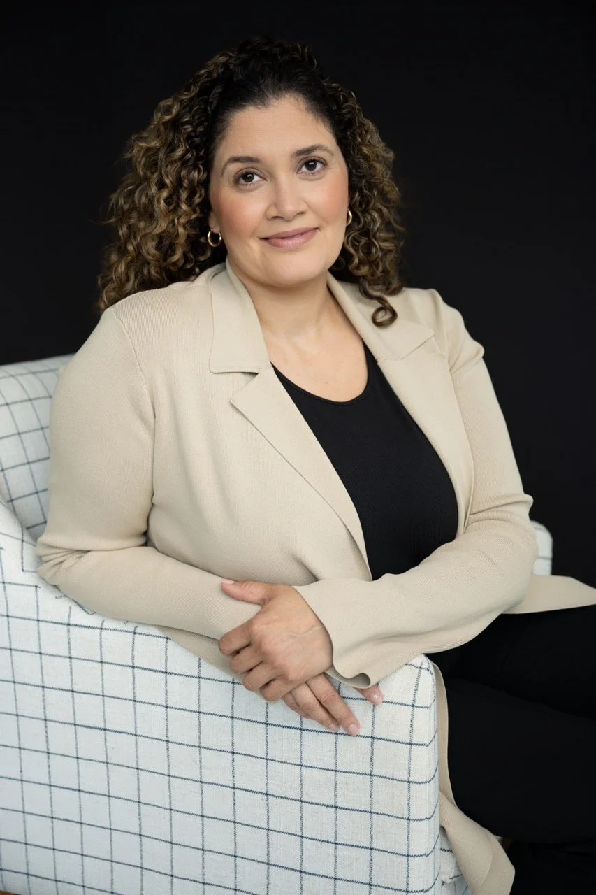 woman sitting-cream blazer-plain backdrop-headshot