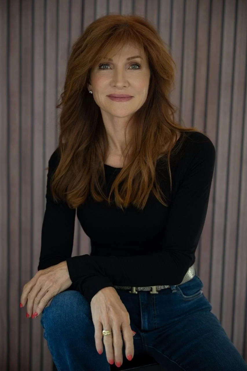 Natural Light portrait of confident red-haired woman in black top and jeans by Austin portrait photographer