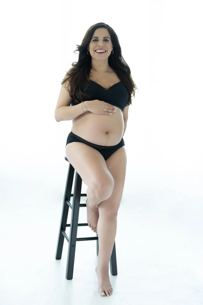 maternity shoot in black underwear sitting on a stool taken by Valentina Portraiture the award winning maternity photographer in Austin, TX
