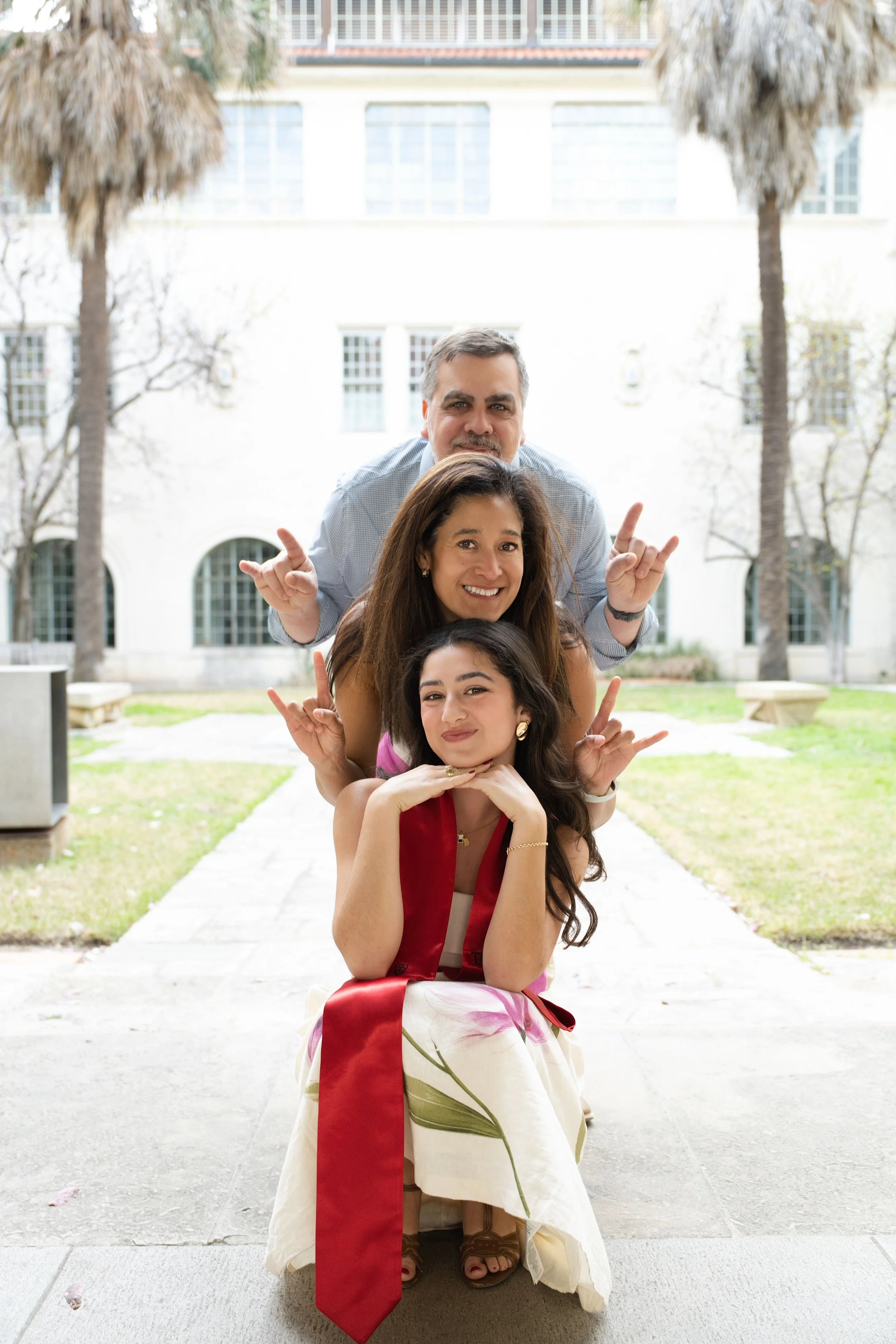 Playful outdoor portrait of couple posing together in courtyard setting