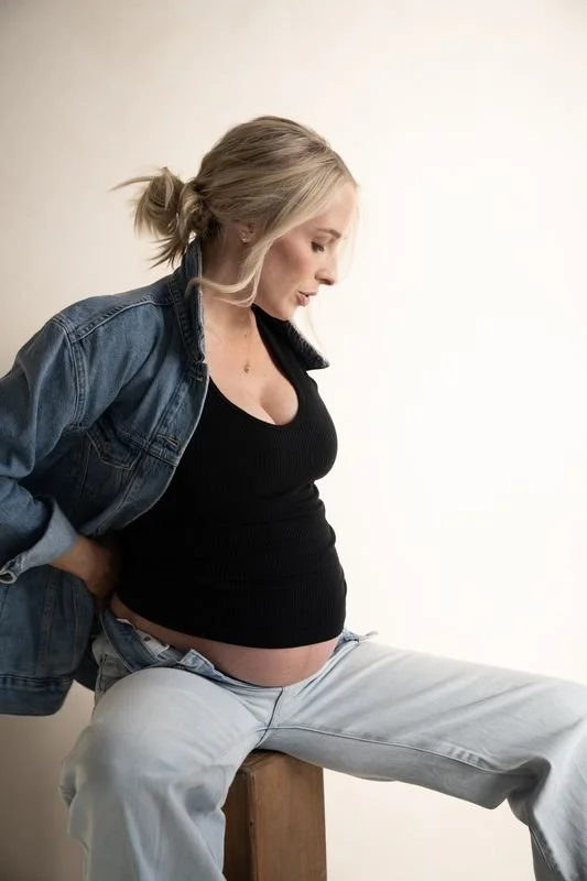 Elegant studio maternity photoshoot in Austin, Texas, celebrating motherhood with modern, natural posing and timeless, refined style.