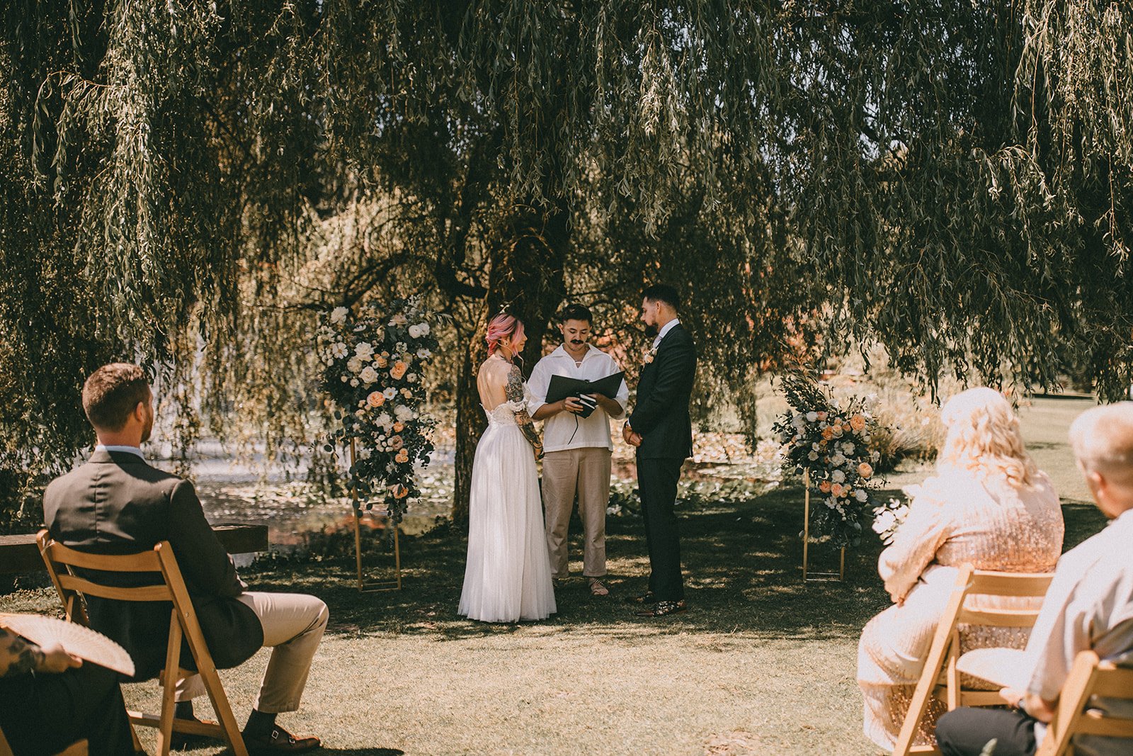 tatooed bride and groom getting married in van dusen botanical gardens