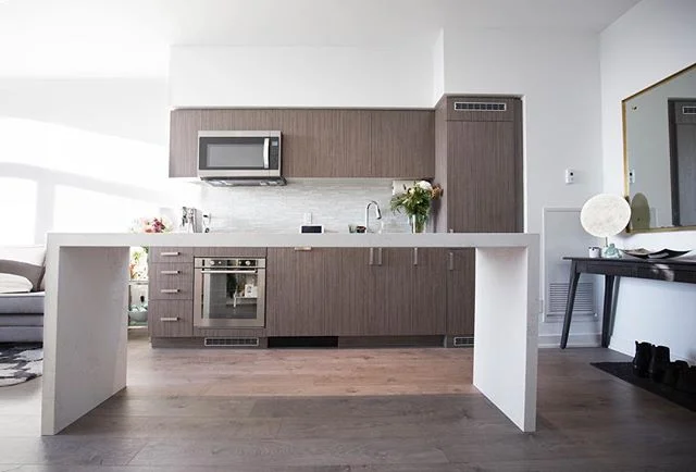 Our modern quartz dining table + prep counters really maximize the limited space in this narrow condo!