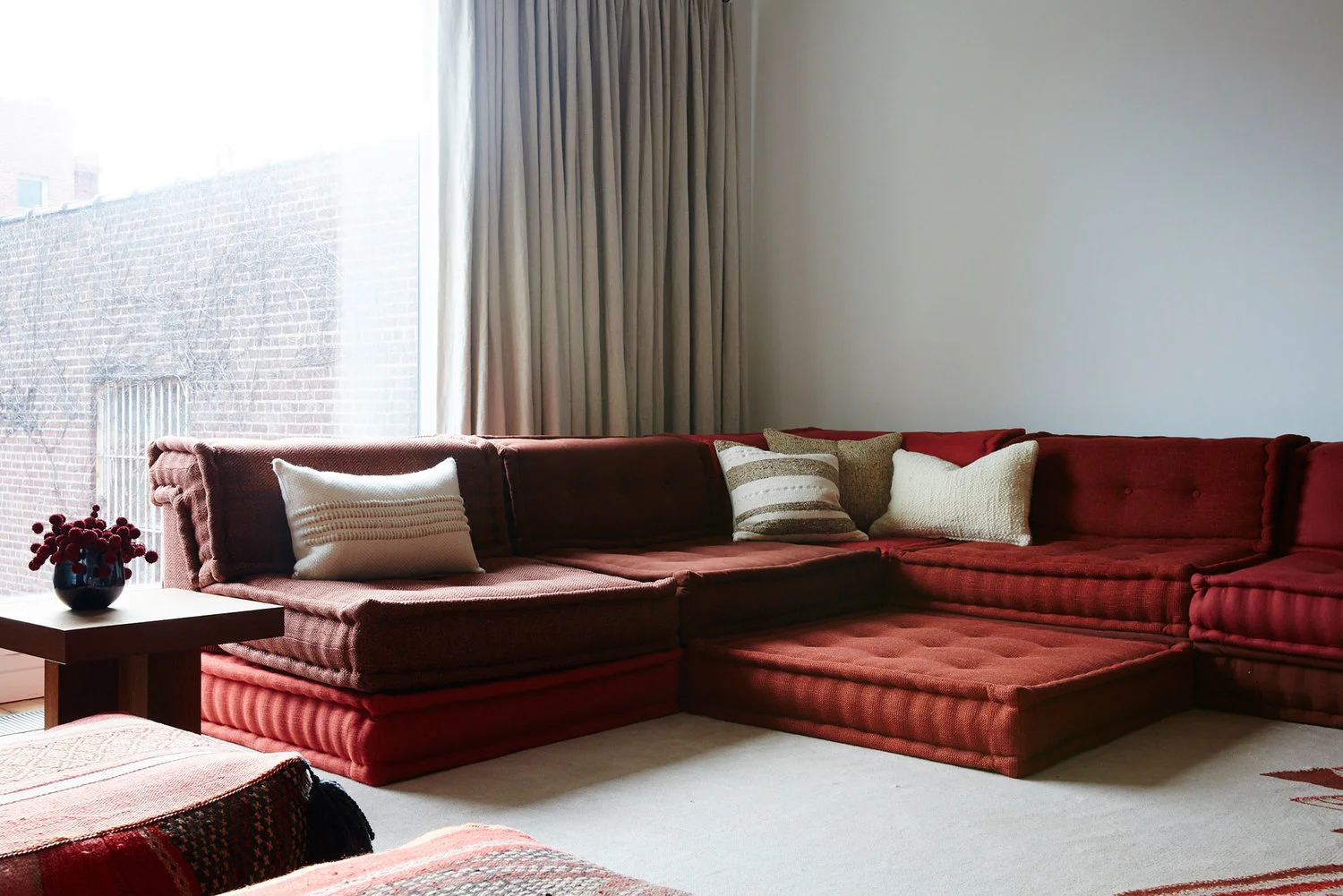 Interior by Jesse Parris-Lamb of New York featuring the Mah-Jong modular sofa. It doesn't get much lower than this! Photo by Nicole Franzen