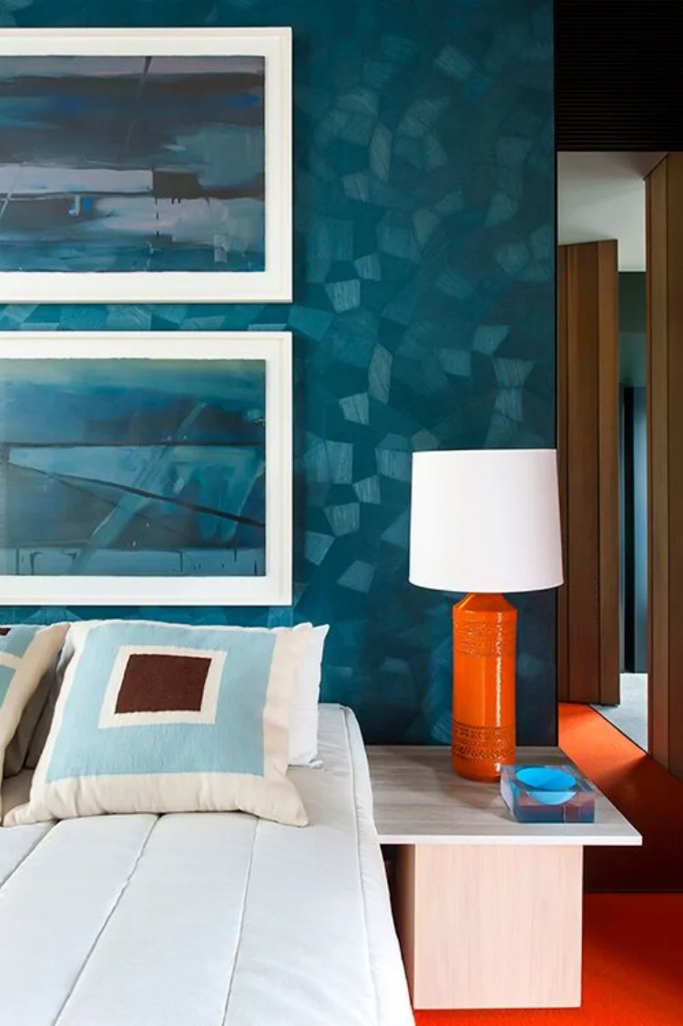 A beautiful blue/teal textured wallpaper is the perfect backdrop to the pops of 'seventies' orange. Interior by SJB