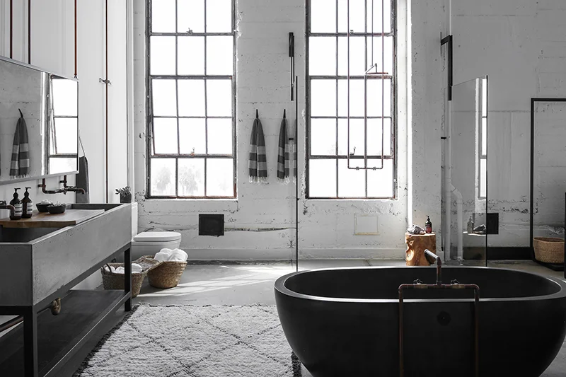 An incredible bathroom by Alexander Design inside a loft space in Los Angeles has retained much of its original features and there isn’t a single tile in sight. Photo – Nicolas Tosi .