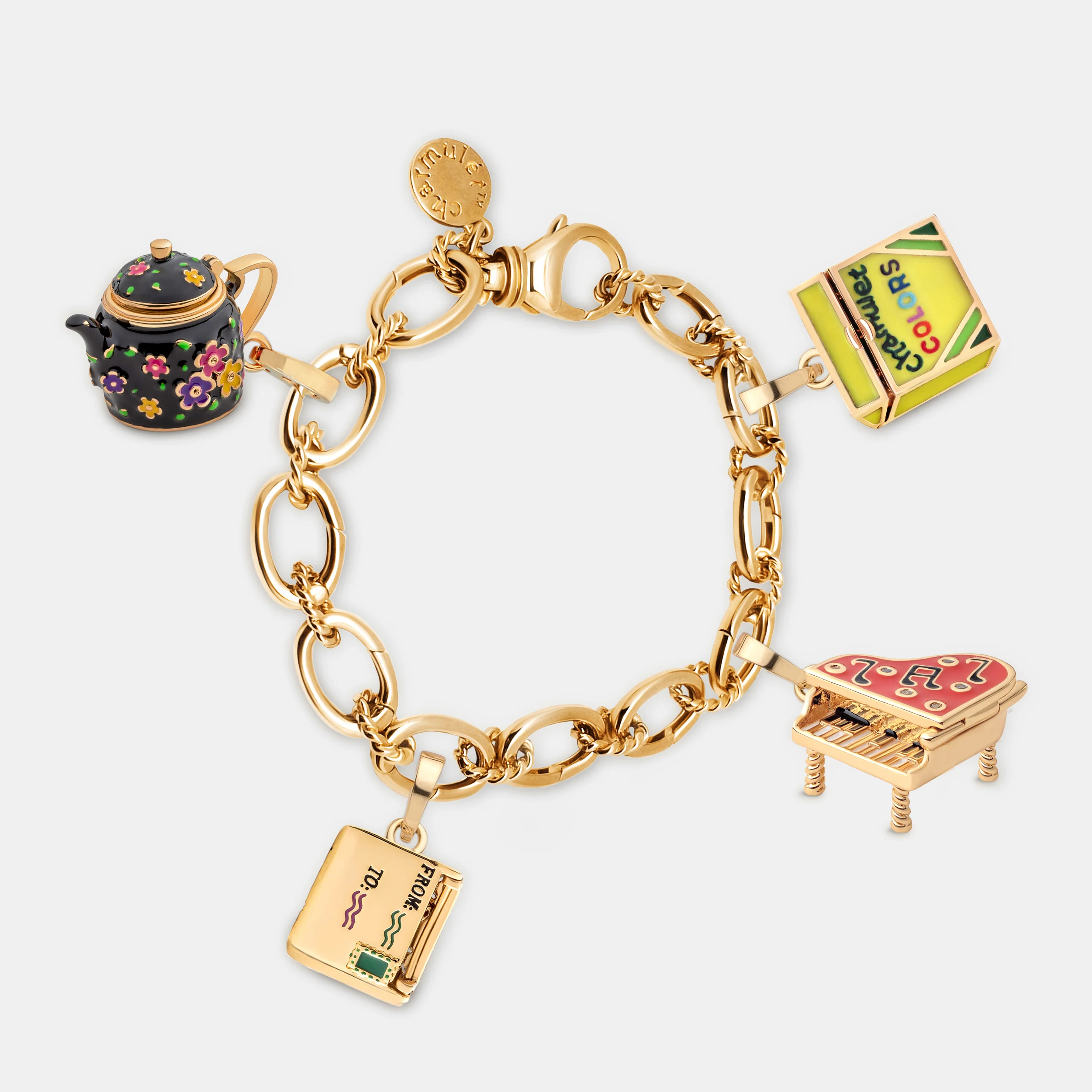 4-charms-on-bracelet-(black-teapot-piano-crayons-envelop)-(around).jpg