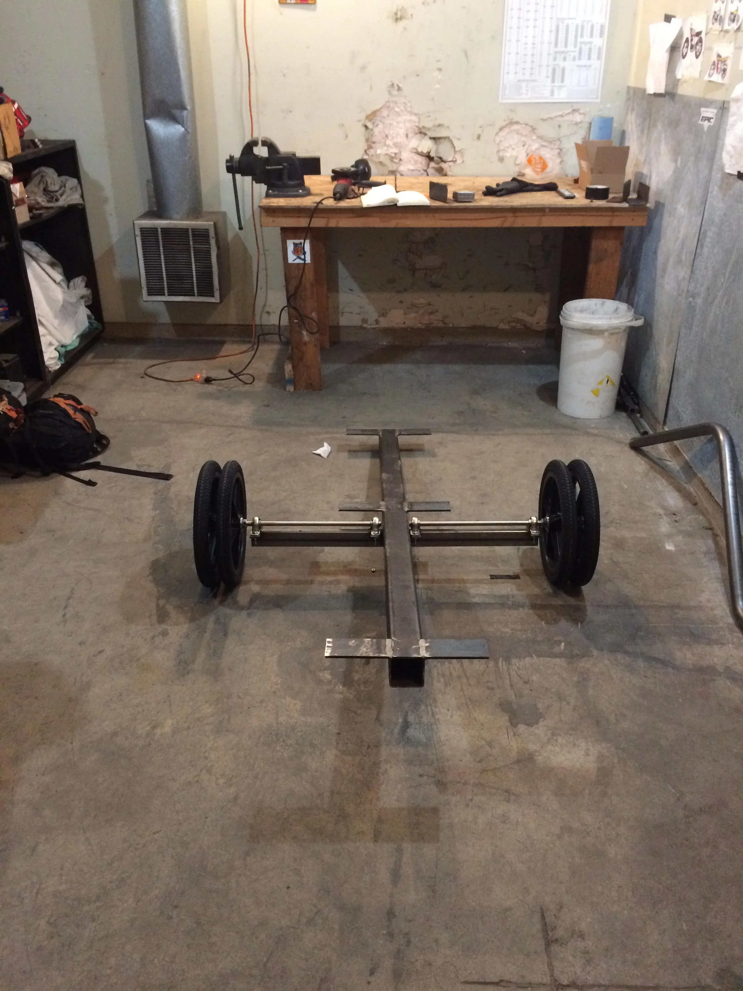 Doubled-up 12" trailer wheels on two separate 5/8" stainless steel axles sit between four pillow blocks, giving the steel frame a durable means for mobility