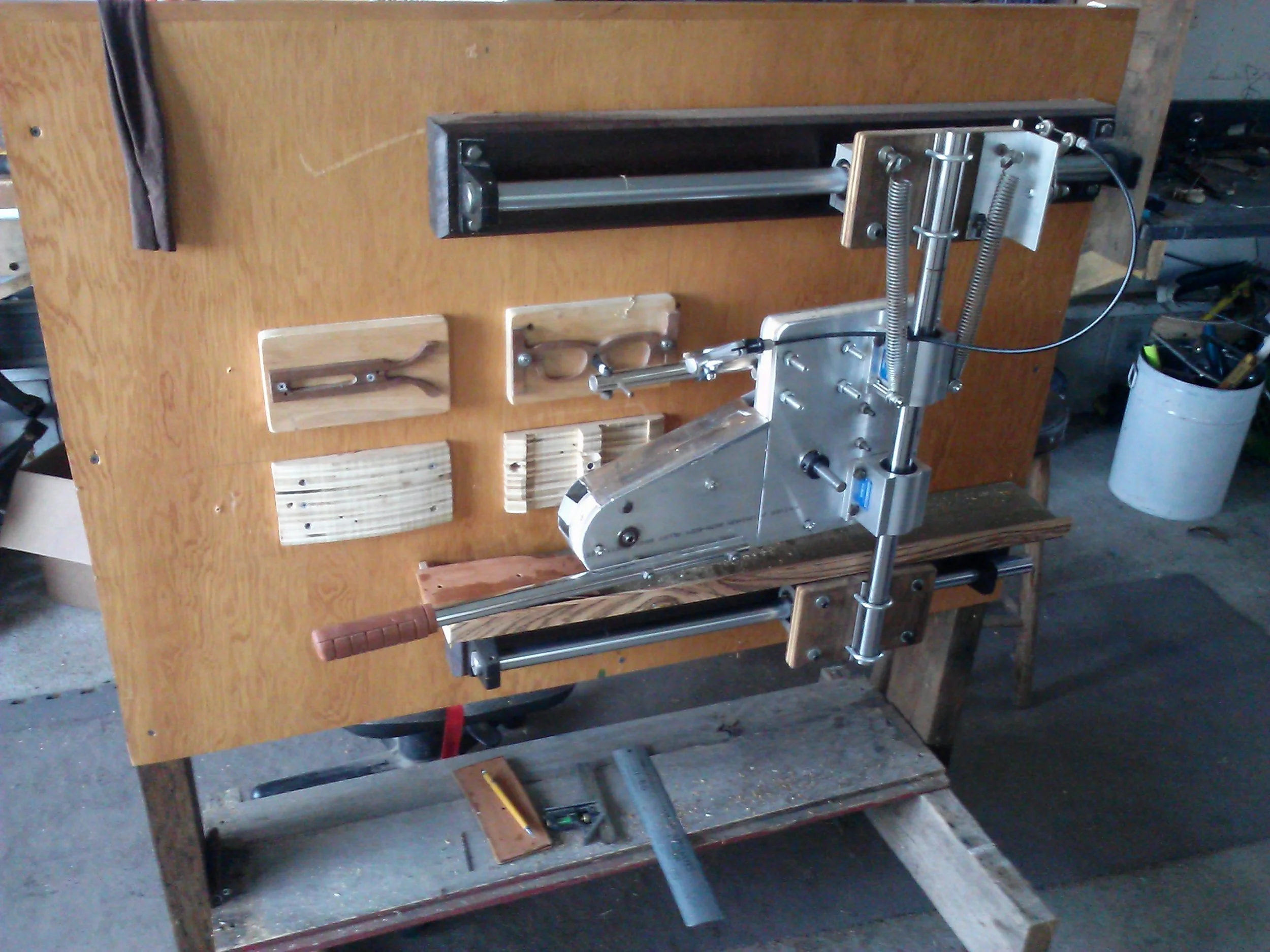 A custom built router powered by the flex shaft- it traces a template and cuts out a new frame from the lower blocks of wood. 