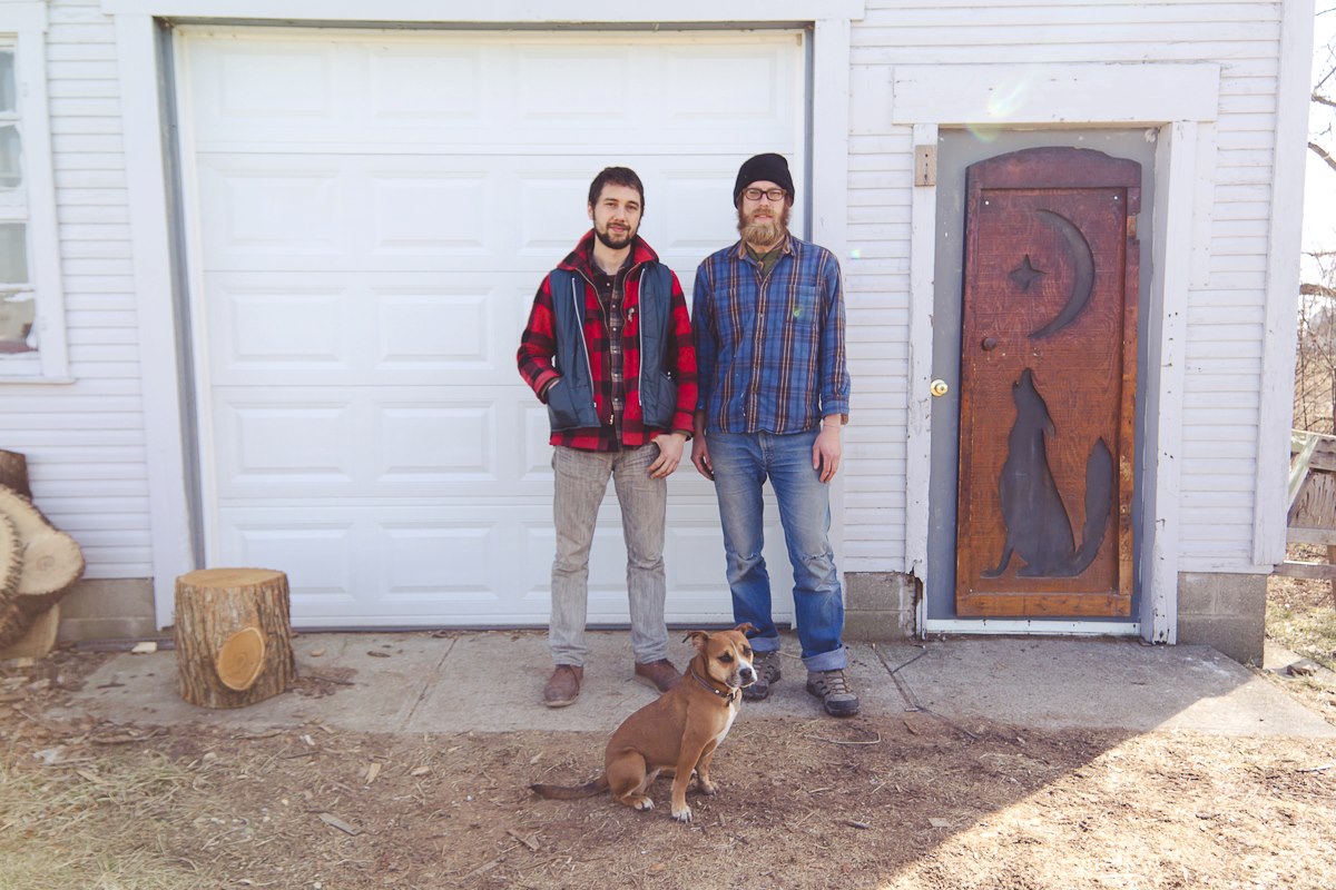 Brett & Dave, with River the dog, in front of their shop
