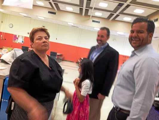 MARK ZARETSKY — NEW HAVEN REGISTER Kamran Farid, right, shares a laugh with Forest School lead cook Sally Paturzo, who was working there back when Farid was a student. With them are Principal Tom Hunt and Farid’s daughter, Salma, 8.