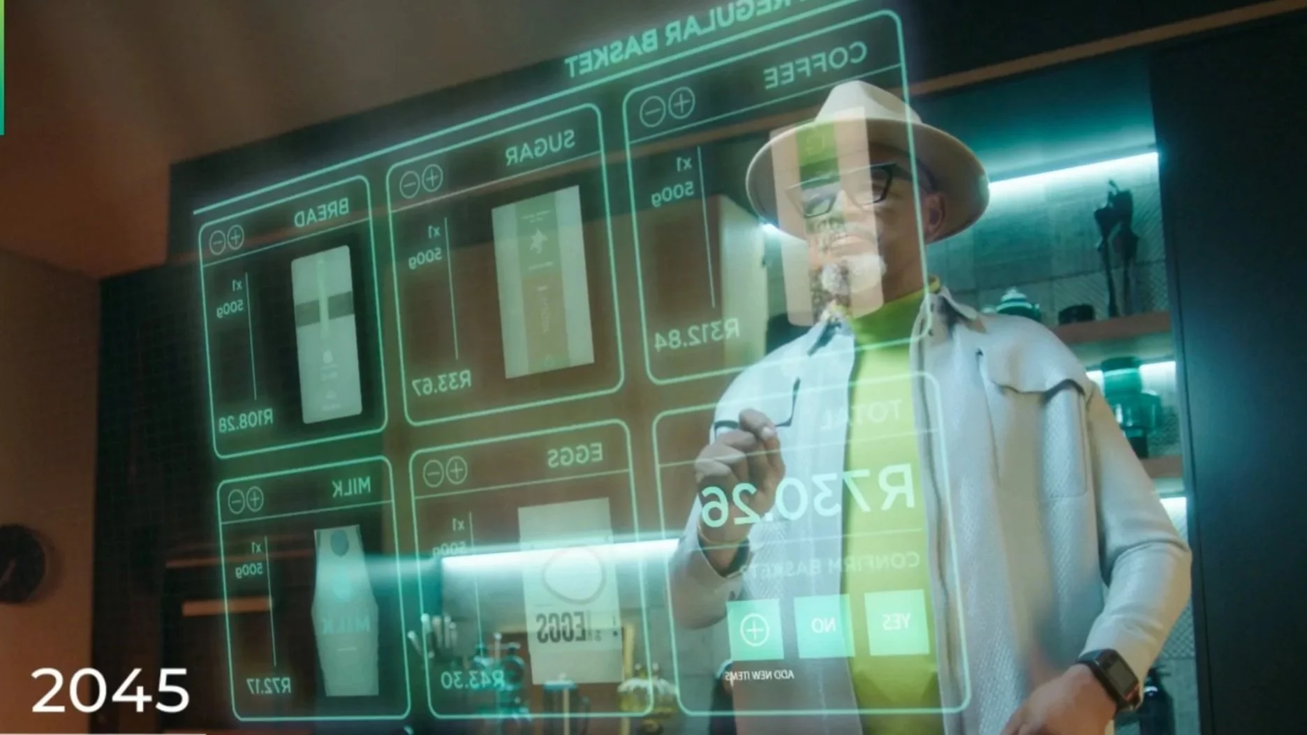 Two adults standing in an elevator against a wood-paneled wall. The woman on the left wears glasses, a tan blazer, and holds a tablet. The man on the right wears glasses, a gray blazer, and a light blue shirt, with a bag strap on his shoulder.