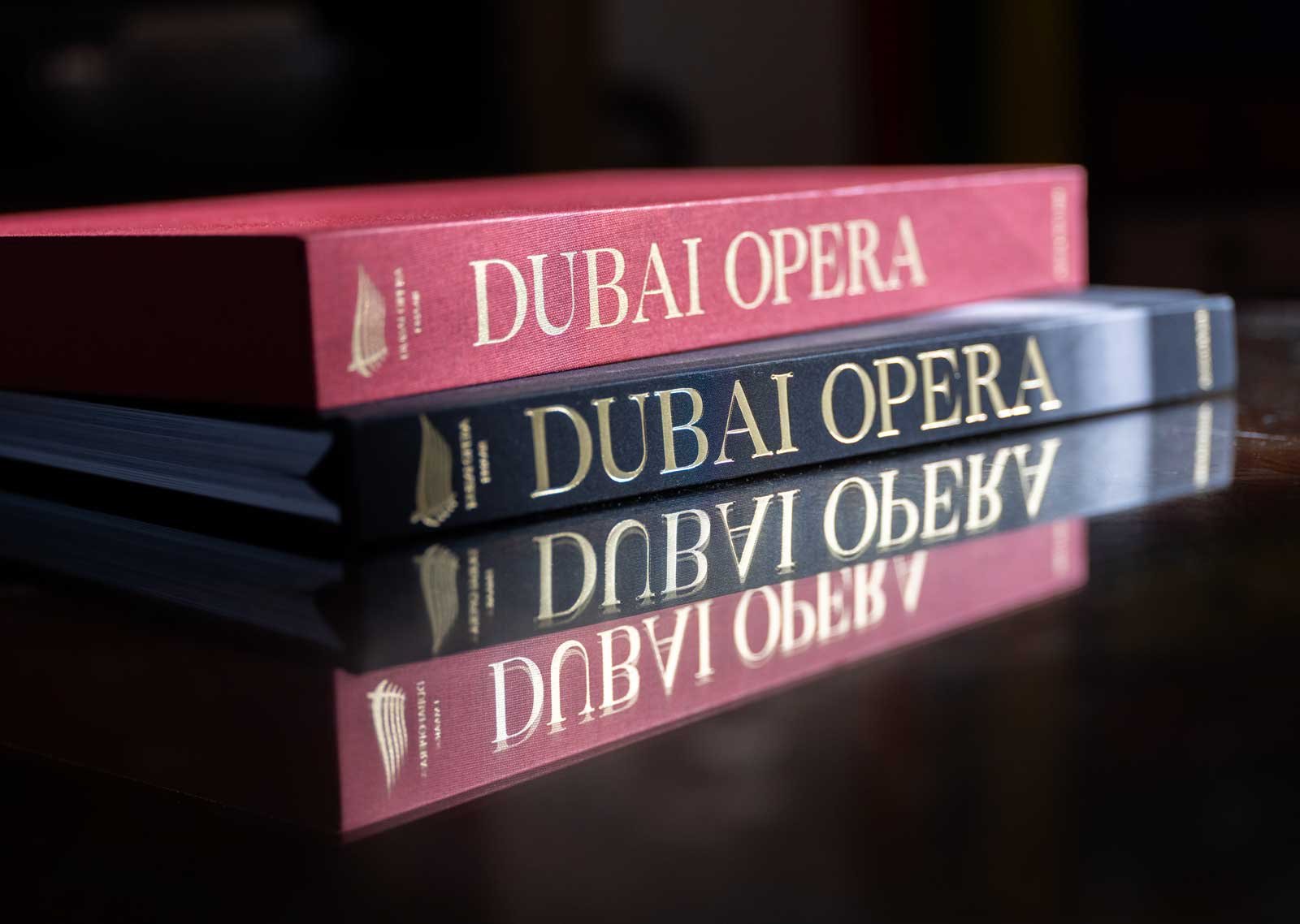 Dubai Opera: House of Cultures, an Assouline book featuring architectural photography by Dany Eid, displayed with its red presentation case and reflected on a polished surface.