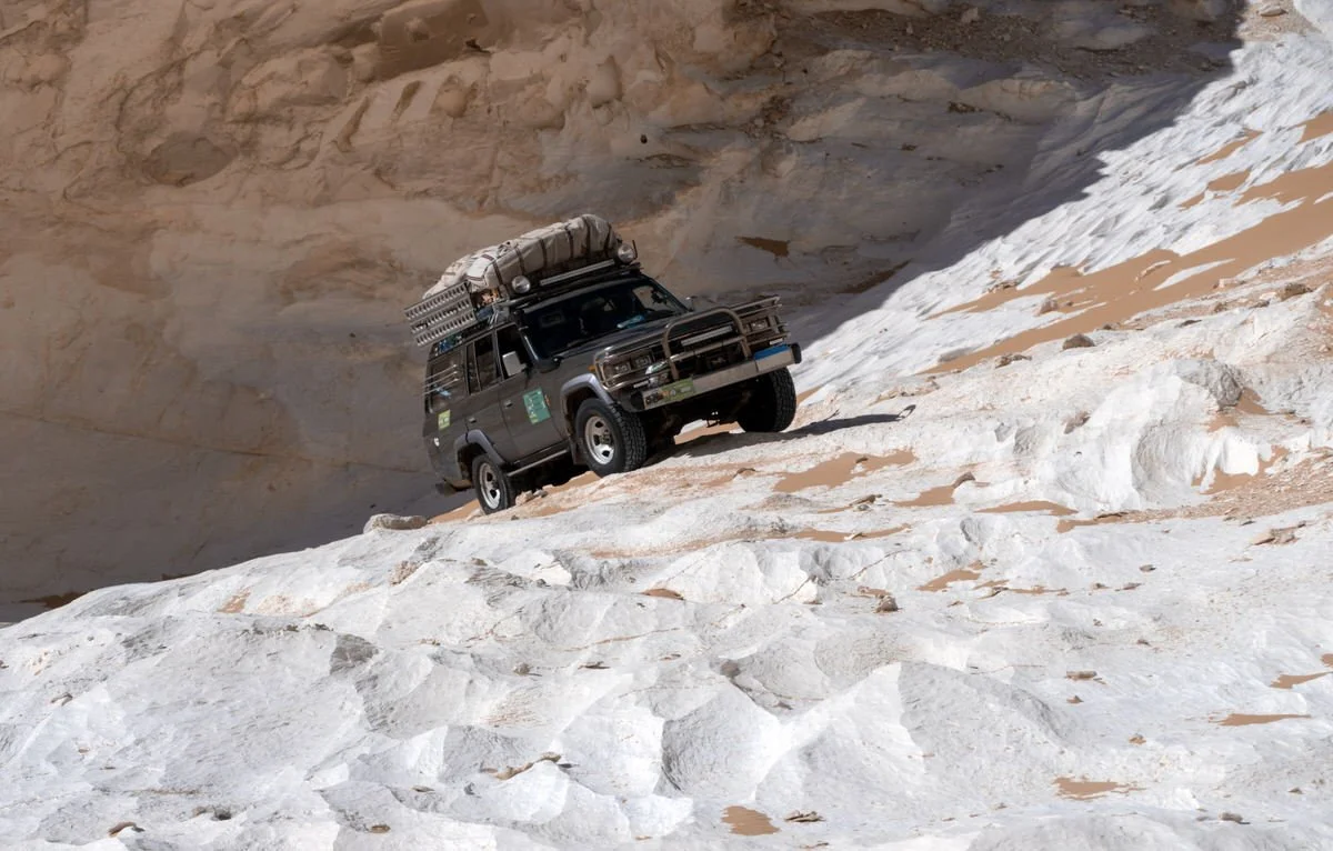 A Toyota Land Cruiser 60 Series equipped for adventure stands on Egypt’s White Desert chalk terrain, photographed by Dany Eid