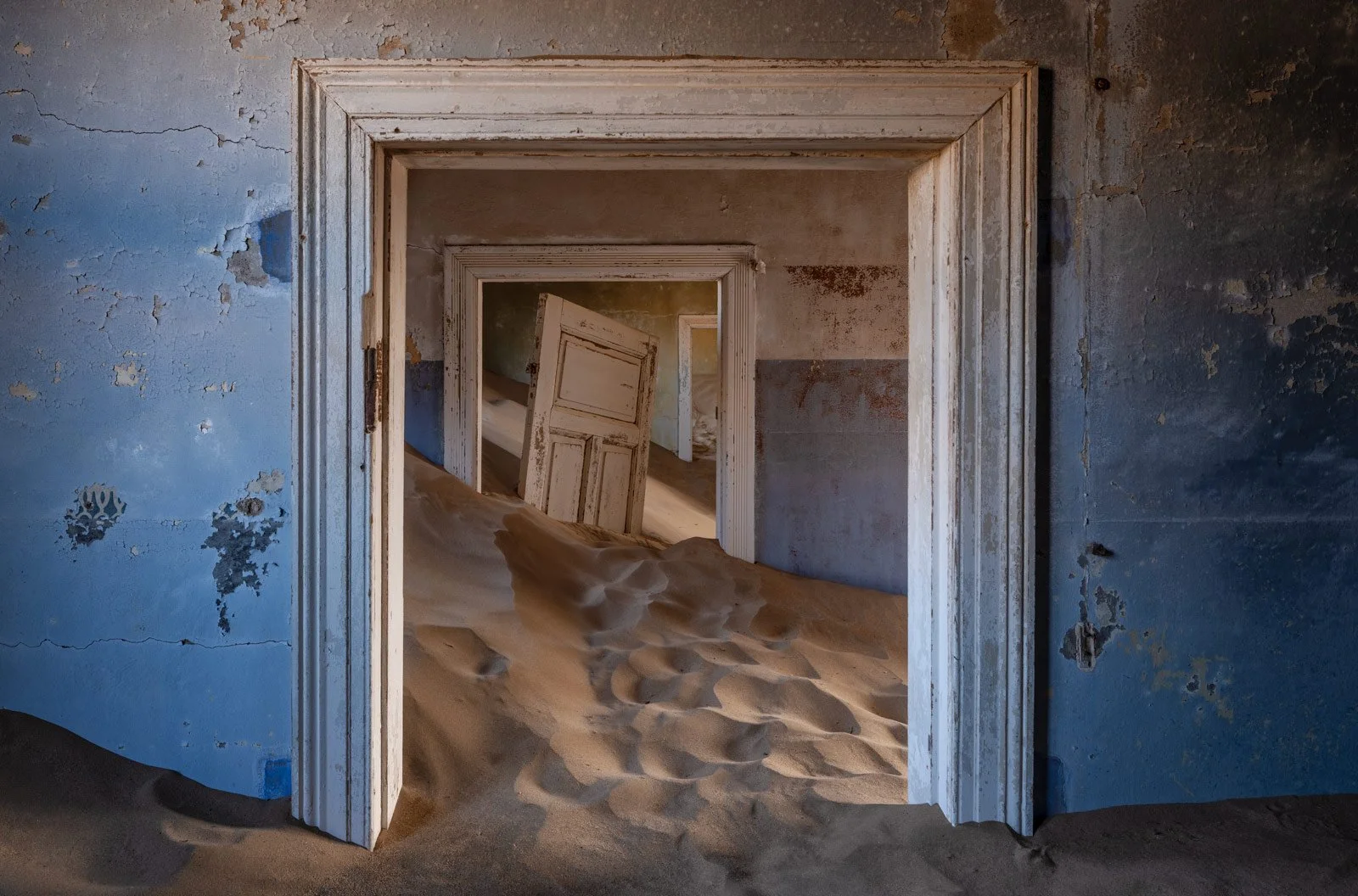 Blue Walls and Shifting Sand at Kolmanskop