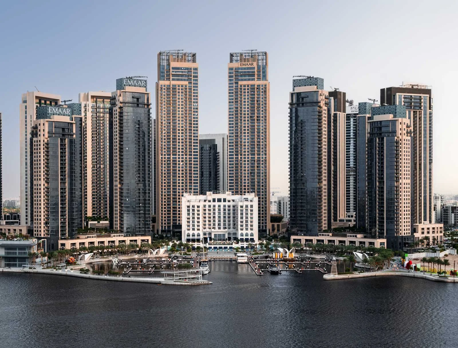 Architectural photograph by Dany Eid showing the symmetrical Emaar residential towers, marina and waterfront at Dubai Creek Harbour, Dubai.