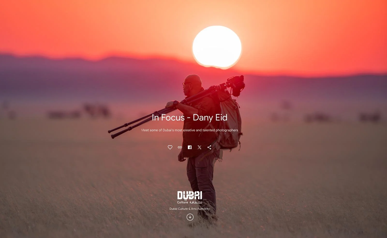 Dany Eid photographing a desert landscape at sunset, carrying professional camera equipment and a tripod.