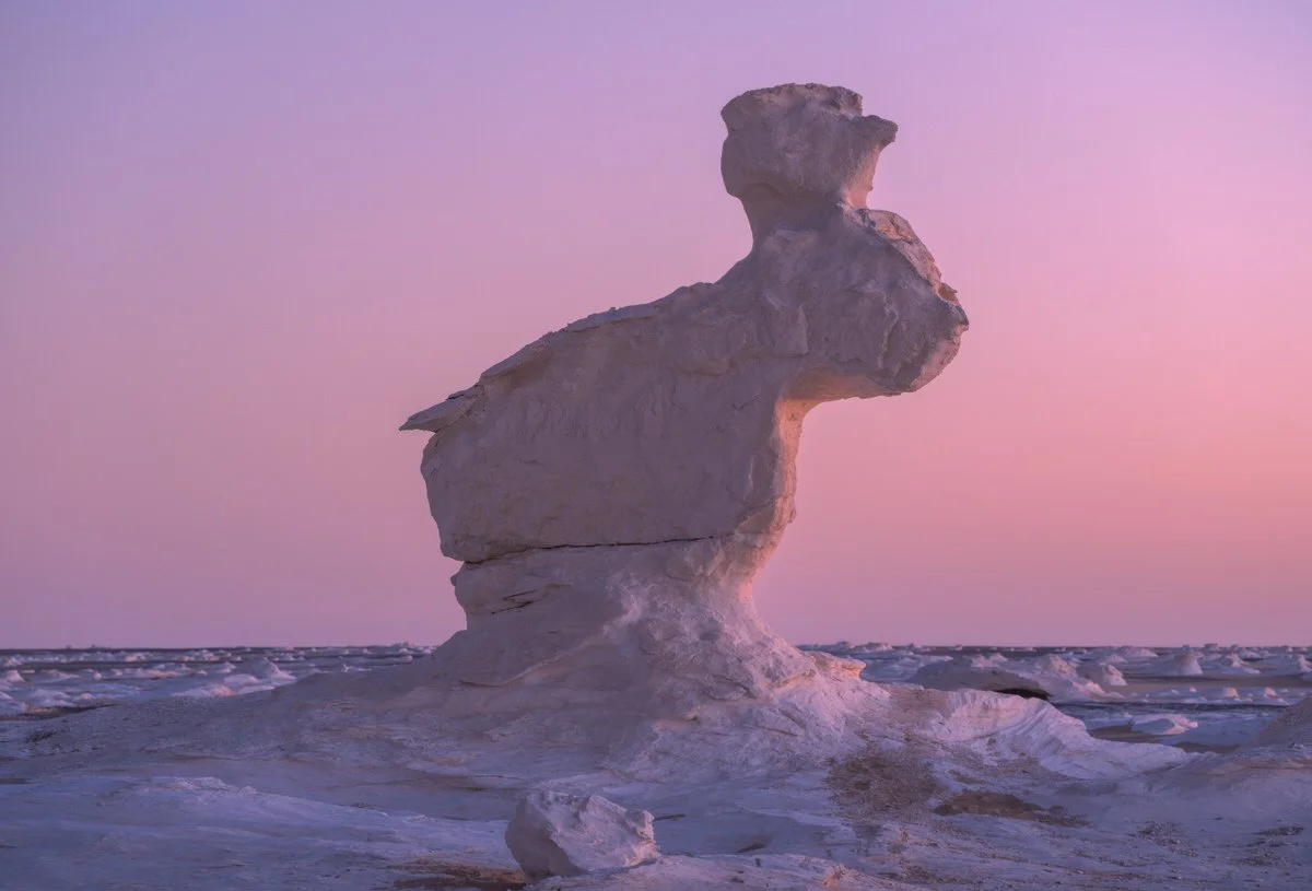 A sculpted chalk formation beneath a pink twilight sky in Egypt’s White Desert, captured by landscape photographer Dany Eid