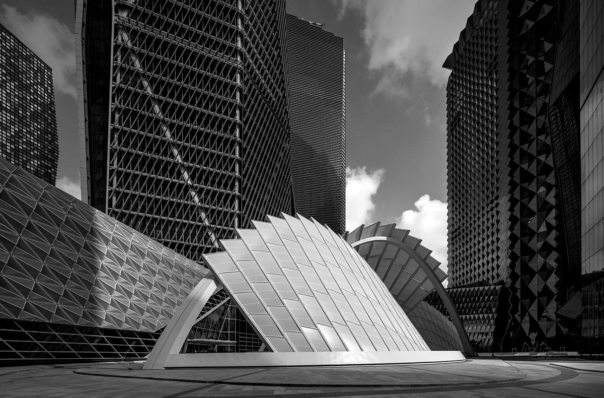 Black and white architectural photograph of towers and a canopy structure at King Abdullah Financial District, Riyadh