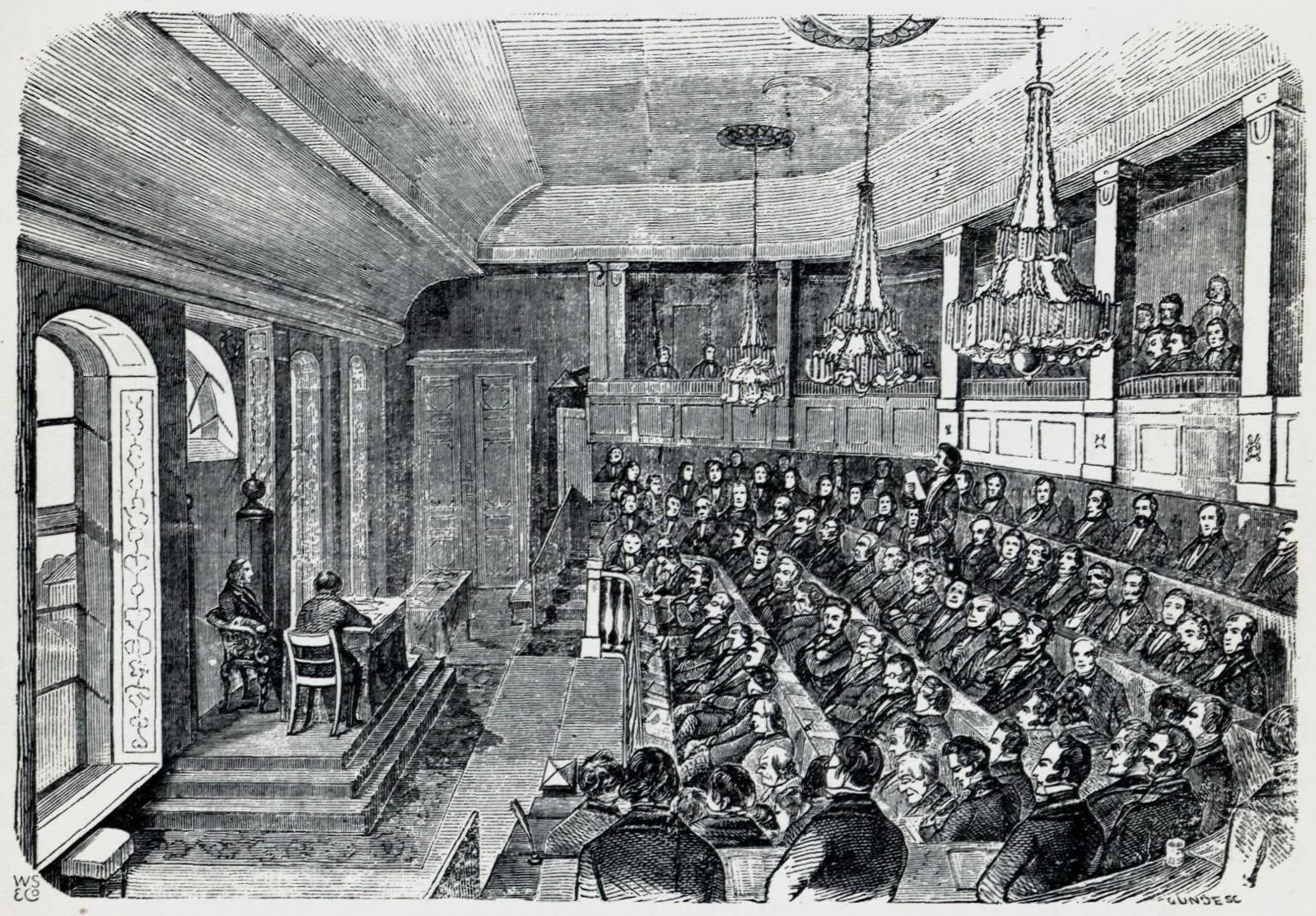 Illustrasjon hentet fra boken "En Christianiensers Erindringer fra 1850- og 60-Aarene" av Nielsen, Yngvar og utgitt av Gyldendal (Kristiania, 1910). Den gamle Storthingssal. Det forsamlede femtende ordentlige Storthing 1857.