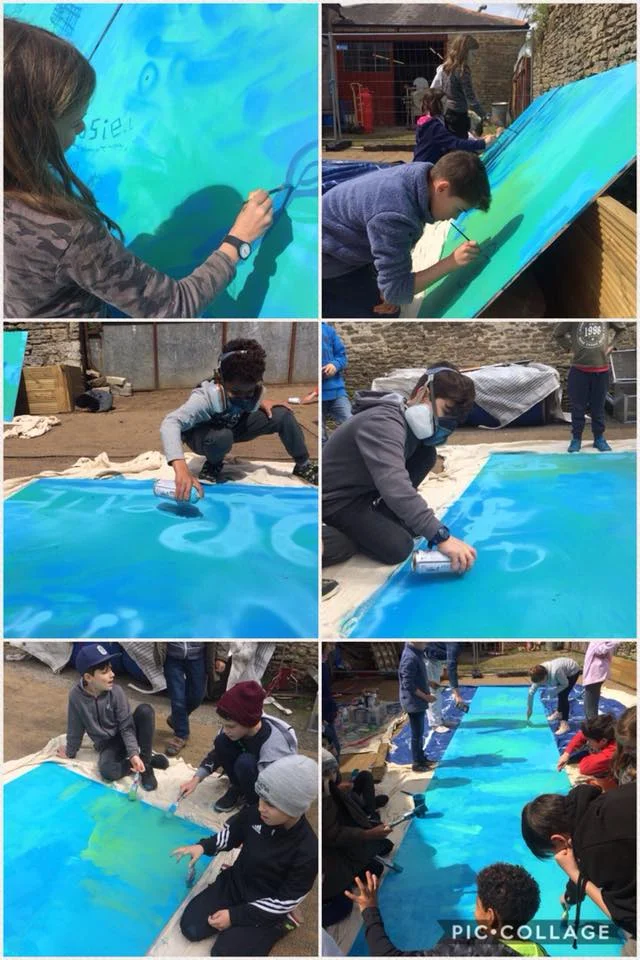 Master working with students to produce some street art for the yard