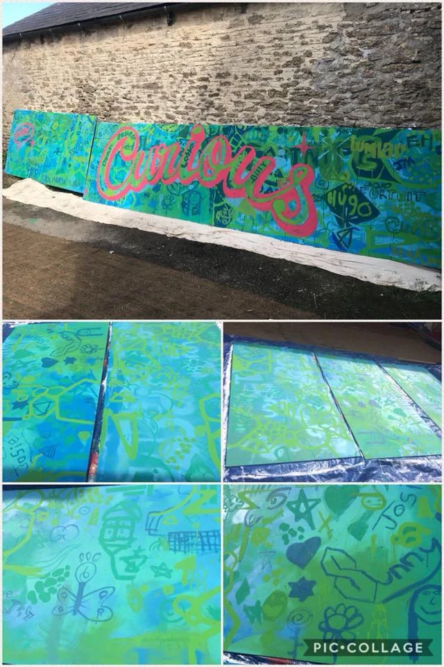 Master working with students to produce some street art for the yard