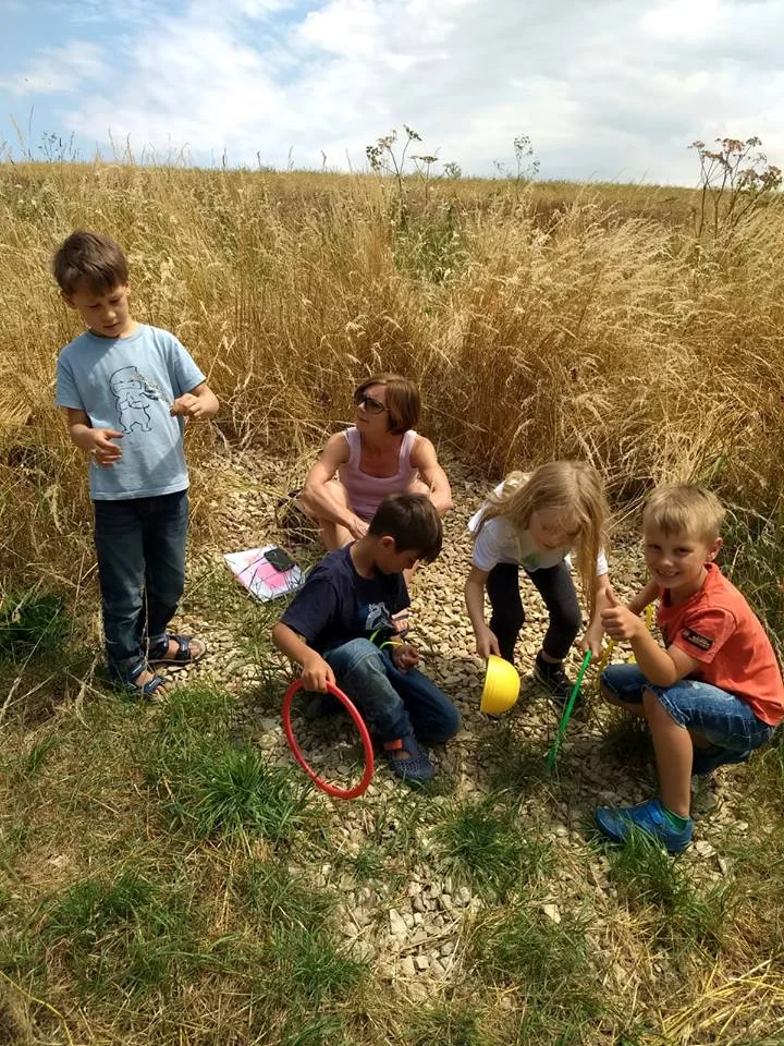 A Master working with the Key Stage 1 group outdoors