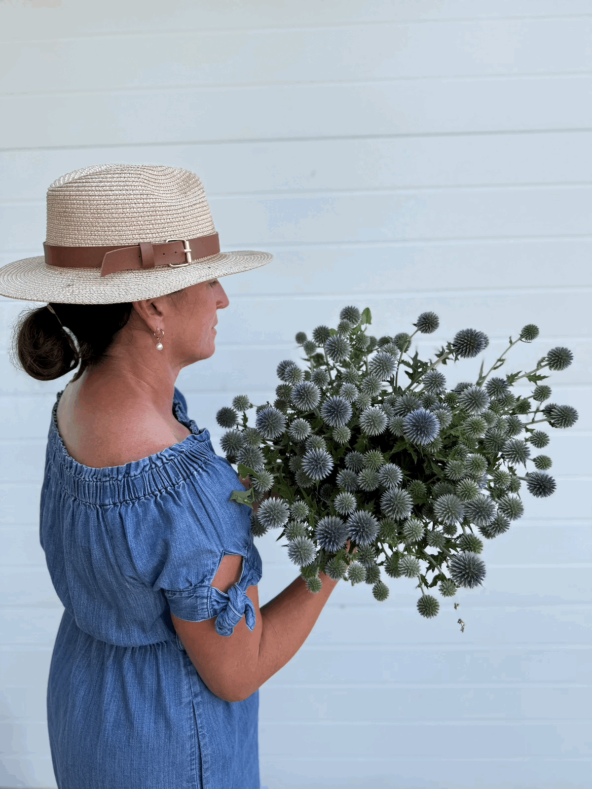 Jenn from PepperHarrow Holding a Bundle of Globe Thistle - Blue (Echinops ritro)
