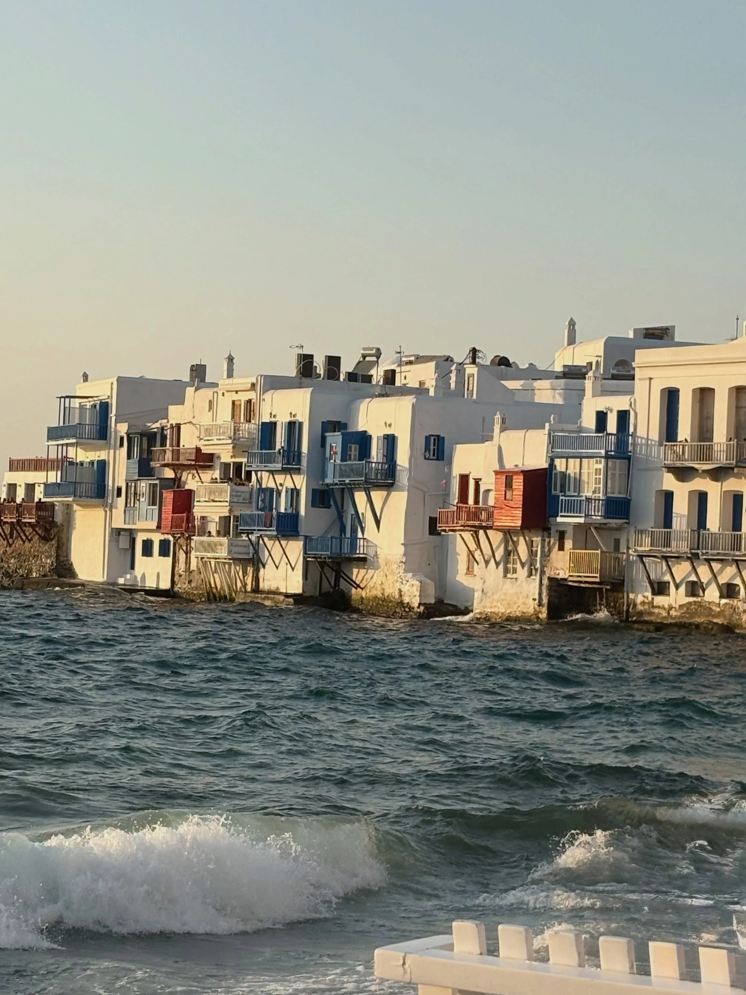 Where Mykonos meets the sea. 💙🇬🇷

There are views you photograph, and then there are views you simply want to sit and stare at.

Along the waterfront of Mykonos Town, the famous whitewashed houses seem to rise straight from the Aegean, their colou