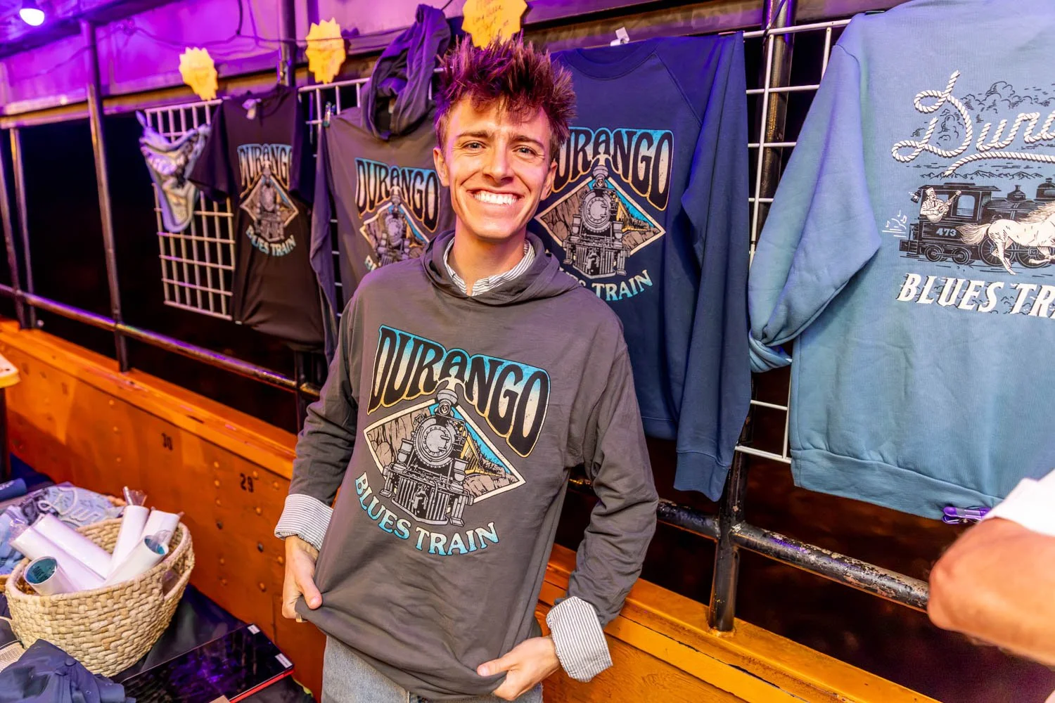 A passenger wears the new merch from the Durango Blues Train showcasing the design and options.