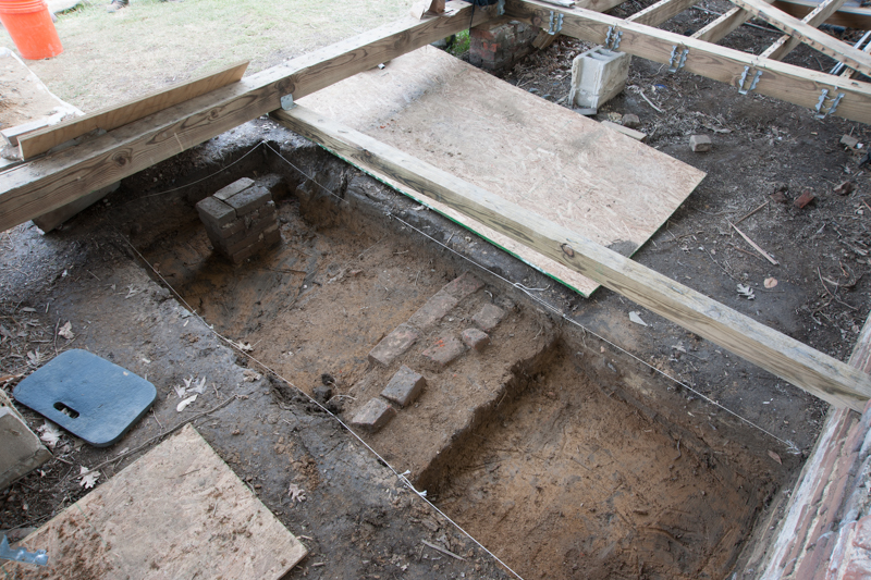 A brick foundation unearthed at the front door from a previous entrance design. 