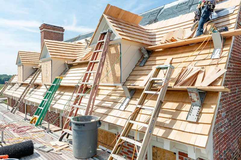 Process photo of the cloverfields main house dormer reconstruction. in this photo the cedar shakes and trim have ben completed. Photo by Pete albert, 2020.