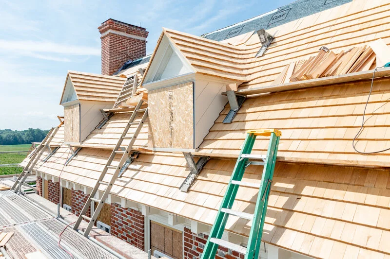 Process photo of the cloverfields main house dormer reconstruction. in this photo the cedar shakes and trim have ben completed. Phot by Pete albert, 2020.