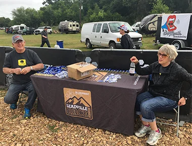 Josh's parents Larry and Chris Colley prepare to distribute medals at the Austin Rattler MTB.