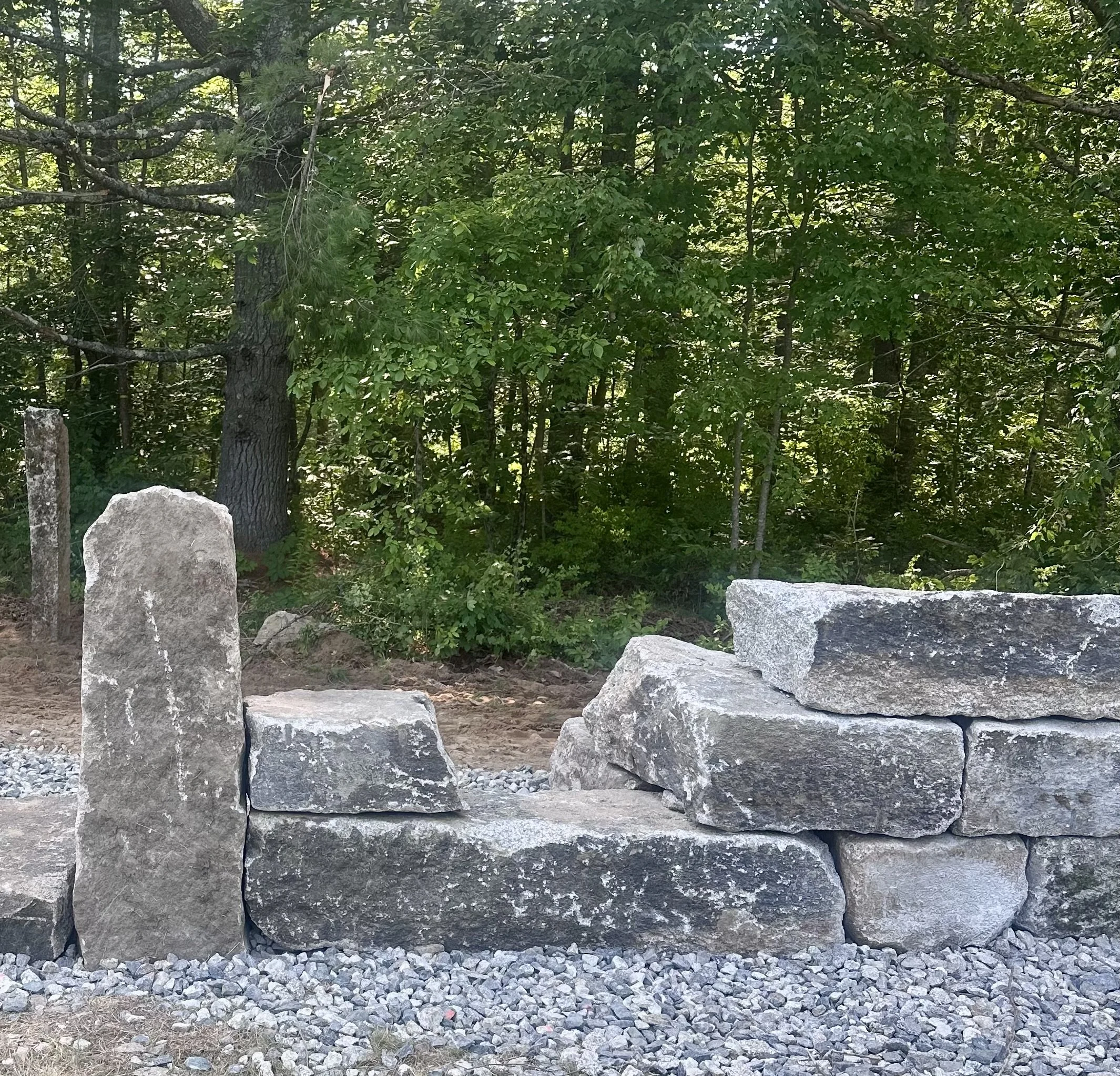 stone wall with reclaimed granite from the edes falls dam at edes falls park in naples maine