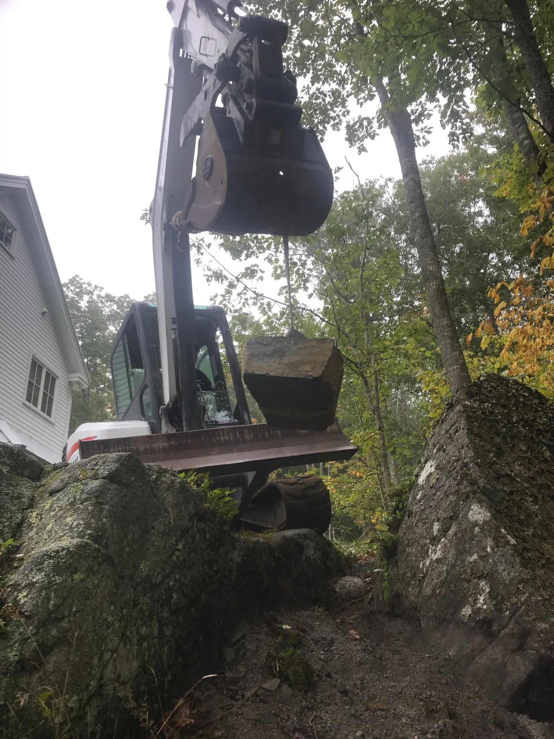 Stones lowered in by excavator
