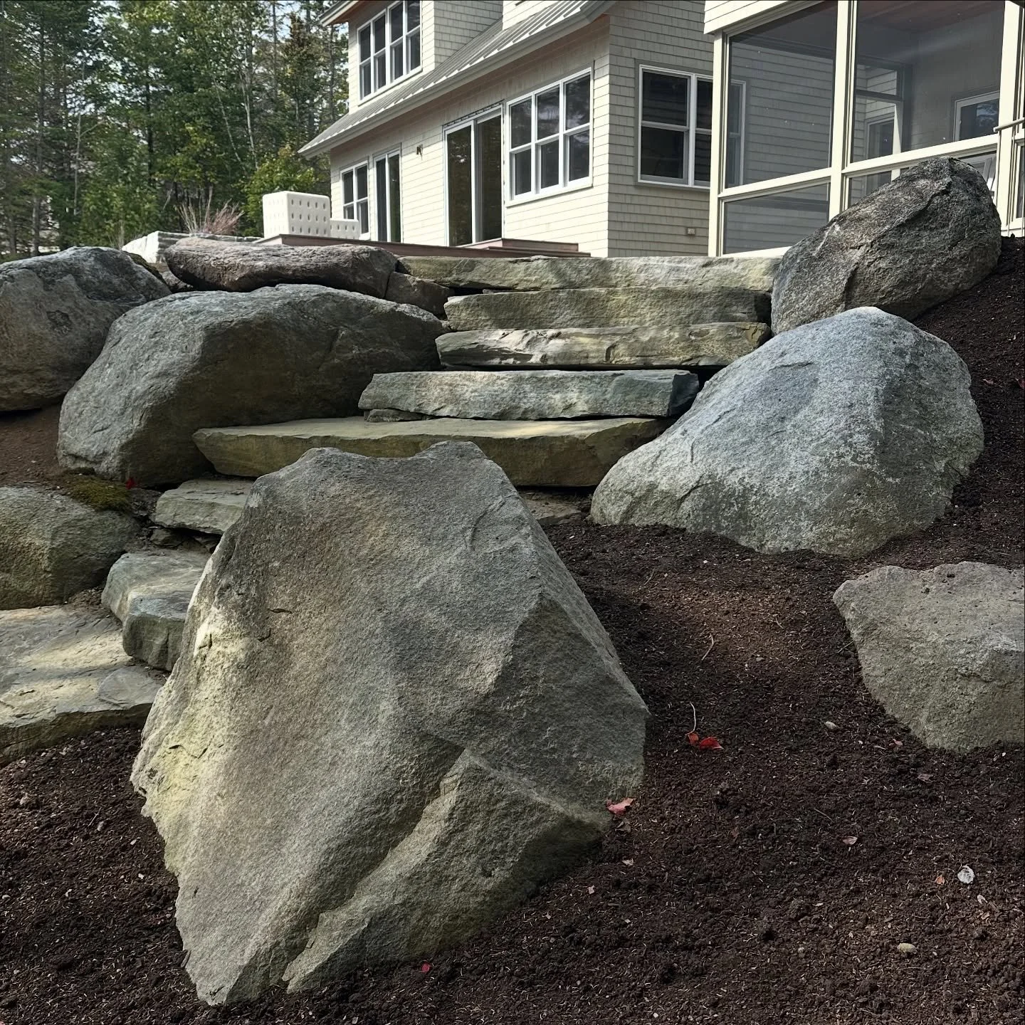 Steps and boulders. 

#stonework 
#boulders 
#stonesteps 
#mainegarden