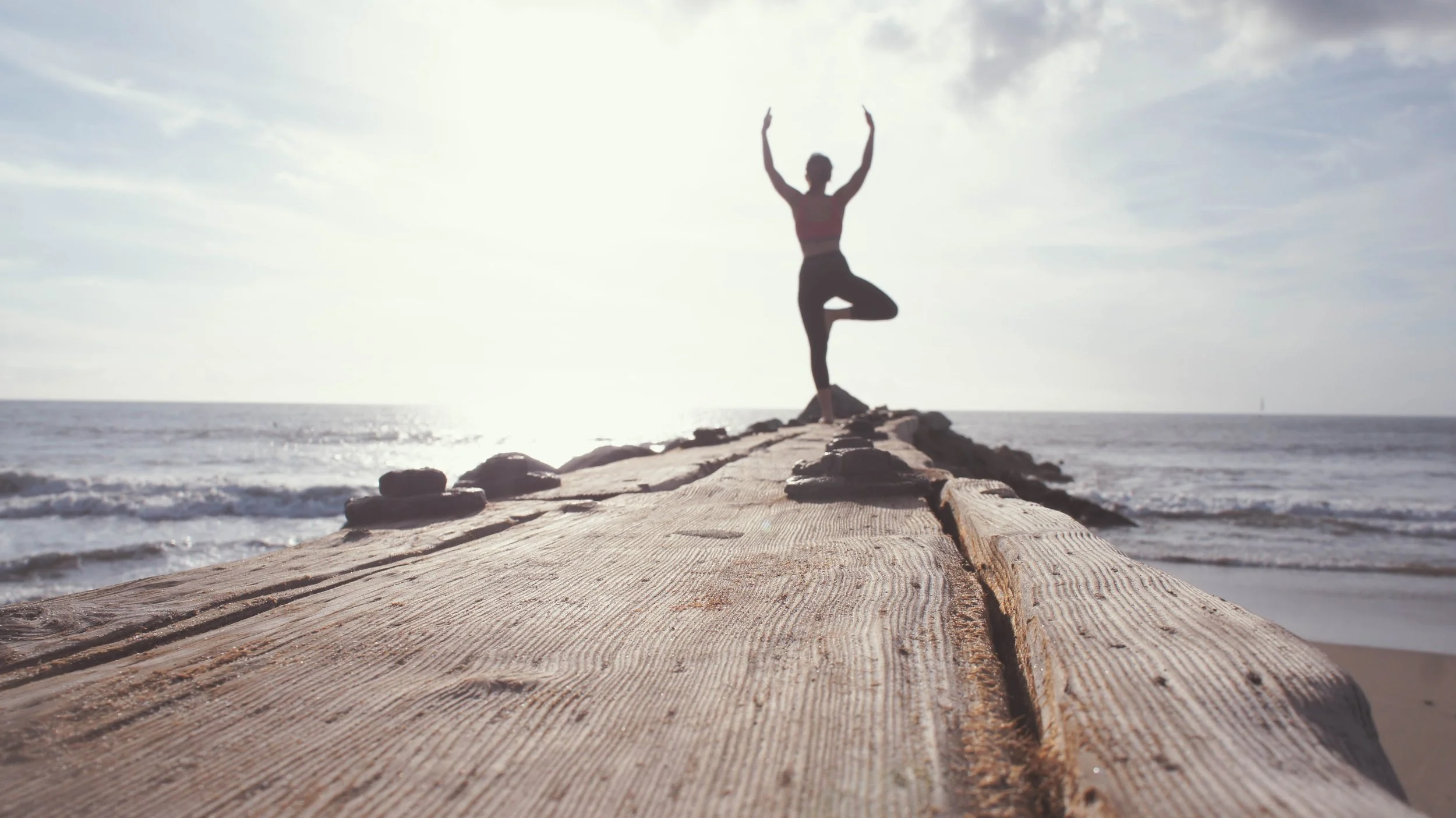 Woman doing  yoga pose on the beach